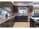 Modern kitchen featuring dark cabinets, stainless steel appliances and granite countertops at 352 Angels Trace Ct, Las Vegas, NV 89148