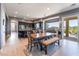 An open floor plan kitchen with dark wood cabinets, stainless appliances, an island, and dining area at 352 Angels Trace Ct, Las Vegas, NV 89148