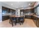 Well-equipped kitchen with dark cabinetry, a center island, stainless steel appliances, and granite countertops at 352 Angels Trace Ct, Las Vegas, NV 89148