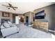 Living area with a fireplace, TV, dresser, sofa and a glimpse of the bonus room at 352 Angels Trace Ct, Las Vegas, NV 89148