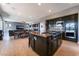 Bright open concept living space featuring a kitchen island with cooktop and dining area at 352 Angels Trace Ct, Las Vegas, NV 89148
