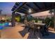 Inviting outdoor dining area with a pergola, comfortable seating, and pool view, perfect for al fresco meals at 352 Angels Trace Ct, Las Vegas, NV 89148