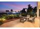 Relaxing patio with a cozy fire pit, comfortable seating, and beautiful landscaping for enjoying outdoor living at 352 Angels Trace Ct, Las Vegas, NV 89148