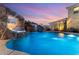Stunning pool featuring a waterfall, slide, and integrated hot tub for ultimate backyard fun at 352 Angels Trace Ct, Las Vegas, NV 89148