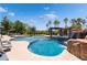 Stunning backyard pool with waterfall feature and surrounded by lush landscaping at 352 Angels Trace Ct, Las Vegas, NV 89148