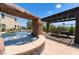 Amazing pool featuring a rock waterfall, spa, and covered outdoor dining area at 352 Angels Trace Ct, Las Vegas, NV 89148