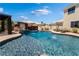 Beautiful backyard pool area with a rock waterfall, slide, spa and covered pergola at 352 Angels Trace Ct, Las Vegas, NV 89148