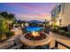 Backyard with pool, rock waterfall, outdoor seating around fire pit, and garden at 352 Angels Trace Ct, Las Vegas, NV 89148