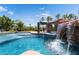 Inviting pool featuring a rock waterfall, spa, and lush landscaping at 352 Angels Trace Ct, Las Vegas, NV 89148