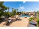 Outdoor living space featuring a stunning pool with waterfall features and a relaxing fire pit seating area at 352 Angels Trace Ct, Las Vegas, NV 89148