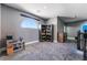 Cozy upstairs landing area featuring gray carpet and a decorative window, perfect for a reading nook at 352 Angels Trace Ct, Las Vegas, NV 89148