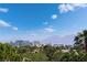 Stunning view showcasing the Las Vegas skyline and mountains in the distance, framed by lush greenery at 352 Angels Trace Ct, Las Vegas, NV 89148