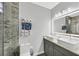 Modern bathroom features double sinks, large, lighted mirror, and a glass enclosed shower at 3591 Gloucester Gate St, Las Vegas, NV 89122