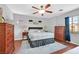 Spacious bedroom with hardwood floors, a ceiling fan, and ample natural light at 3591 Gloucester Gate St, Las Vegas, NV 89122