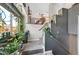 Bright entryway with staircase, decorative plants, and natural light from a large window at 3591 Gloucester Gate St, Las Vegas, NV 89122
