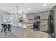 Modern kitchen with a large island, stainless steel appliances, and pendant lighting at 3591 Gloucester Gate St, Las Vegas, NV 89122