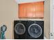 Convenient laundry room with front load washer and dryer and cabinet storage above at 3591 Gloucester Gate St, Las Vegas, NV 89122