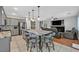 Open-concept kitchen and living room area with a fireplace and comfortable seating at 3591 Gloucester Gate St, Las Vegas, NV 89122