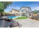 Inviting backyard features a sparkling pool, lounge area, pergola with dining set, and small grassy area at 3591 Gloucester Gate St, Las Vegas, NV 89122