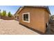 View of the backyard featuring a low wall and gravel landscaping around the stucco house at 368 Calabria Beach St, Henderson, NV 89015