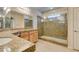 Bright bathroom featuring a large, glass-enclosed shower and double sink vanity with granite counters at 368 Calabria Beach St, Henderson, NV 89015