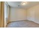 Neutral bedroom with carpeted floor, window with light-filtering curtains, and overhead light at 368 Calabria Beach St, Henderson, NV 89015