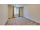 Carpeted bedroom with window, light-filtering curtains, and simple, clean design at 368 Calabria Beach St, Henderson, NV 89015