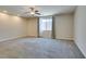 Large carpeted bedroom with a ceiling fan, window, and light-filtering curtains at 368 Calabria Beach St, Henderson, NV 89015
