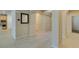 Hallway with modern tile flooring, arched doorways, and glimpses of the kitchen and other rooms at 368 Calabria Beach St, Henderson, NV 89015