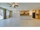Open-concept kitchen and living area featuring wood cabinets, granite countertops, and tile flooring at 368 Calabria Beach St, Henderson, NV 89015