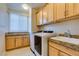 Spacious laundry room features front-load machines and custom cabinets at 368 Calabria Beach St, Henderson, NV 89015