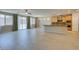 Open-concept living area with tile floors, large windows, and a bar leading into kitchen at 368 Calabria Beach St, Henderson, NV 89015
