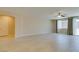 Neutral living space with light tile flooring, ceiling fan, large window and access to other rooms at 368 Calabria Beach St, Henderson, NV 89015