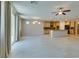 Spacious living room with light tile flooring, ceiling fan, and an open layout to the kitchen at 368 Calabria Beach St, Henderson, NV 89015