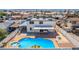 This backyard features a private pool, an outdoor lounge area, and a desert landscape at 3748 Silent Hill Dr, Las Vegas, NV 89147