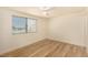 Bright bedroom with modern wood floors, neutral walls, and a sunlit window at 3748 Silent Hill Dr, Las Vegas, NV 89147