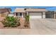 Exterior shot of single-story home featuring desert landscaping, a driveway, and an attached two-car garage at 3748 Silent Hill Dr, Las Vegas, NV 89147