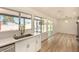 Bright living space with new wood flooring, a view of the pool, and access to a modern kitchen at 3748 Silent Hill Dr, Las Vegas, NV 89147