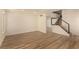 Minimalist living area featuring modern wood floors, a freshly painted interior, and a staircase at 3748 Silent Hill Dr, Las Vegas, NV 89147