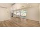 Open-concept living space featuring new wood flooring, fresh paint, and views of the backyard and pool at 3748 Silent Hill Dr, Las Vegas, NV 89147