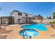Backyard oasis with pool, spa, and covered patio, ideal for entertaining or serene relaxation at 3748 Silent Hill Dr, Las Vegas, NV 89147