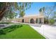 View of the home's exterior with a covered patio and artificial turf in the backyard at 3790 W Moberly Ave, Las Vegas, NV 89139