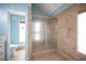 Bathroom with a walk-in shower and a toilet and a view to outside at 3790 W Moberly Ave, Las Vegas, NV 89139