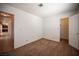 Carpeted bedroom with a closet and view to the hallway and kitchen at 3790 W Moberly Ave, Las Vegas, NV 89139