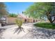 Home exterior showcasing desert landscaping, a covered patio, and a lush green lawn at 3790 W Moberly Ave, Las Vegas, NV 89139