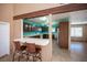 Open kitchen with stainless steel appliances and dark cabinetry with a breakfast bar at 3790 W Moberly Ave, Las Vegas, NV 89139