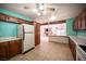 Open kitchen layout with modern appliances, wood cabinets and a view to the living spaces at 3790 W Moberly Ave, Las Vegas, NV 89139