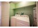 A well lit laundry room featuring a washer, dryer, and water heater at 3790 W Moberly Ave, Las Vegas, NV 89139