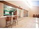 View of the living room with the kitchen in the background and bar stool seating at 3790 W Moberly Ave, Las Vegas, NV 89139