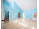 Light-filled bedroom featuring high ceilings, blue walls, and tiled floors at 3790 W Moberly Ave, Las Vegas, NV 89139